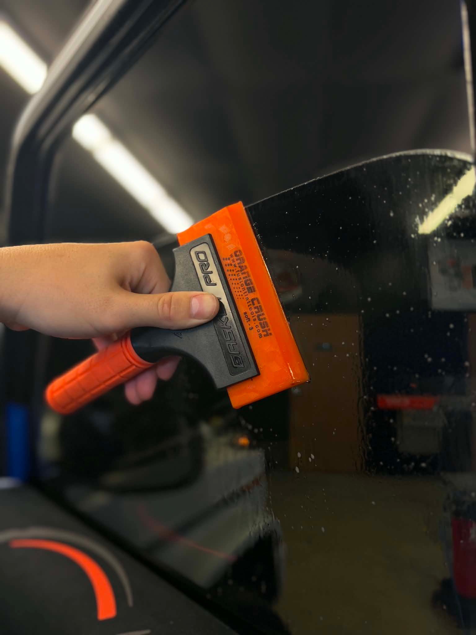 Close up of squeegee on tinted windows